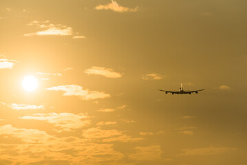 airplane in the sky at sunset