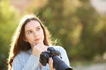 Doubtful photographer holding camera