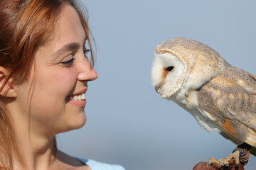 Woman and owl looking each other