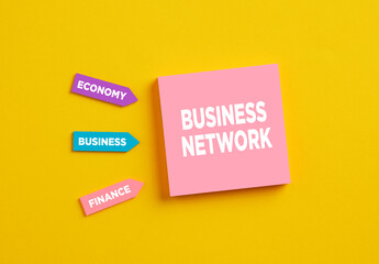 The word business network on pink note paper. The determinants of business networking.