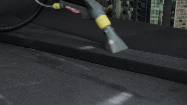 Professional dry cleaning of the sofa with a special chemical solution and a washing vacuum cleaner. Copy space for text