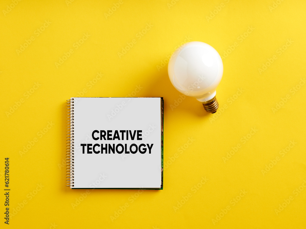 Poster the message creative technology on notepad with a light bulb. creative technology development or inv