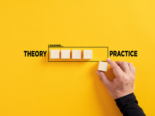 Transition of theory into practice. Implementation of theories in practice. Hand places a wooden...