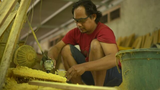 Professional artisans are making traditional Javanese wooden dolls called wayang. The initial process of making this traditional puppet was made from whole wood which was cut and smoothed