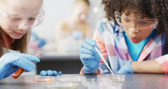 Diverse happy schoolchildren having science class in school lab
