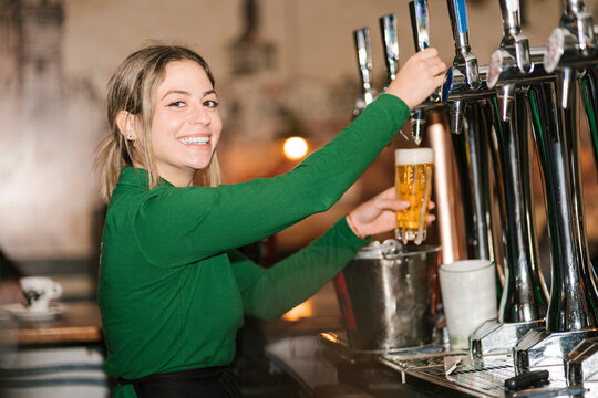 Hands typing on illuminated laptop keyboard in dark at home office