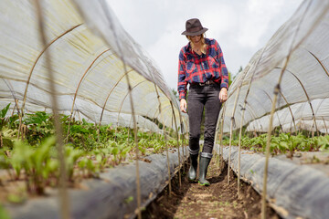 Smiling mature businesswoman talking on mobile phone at sidewalk cafe
