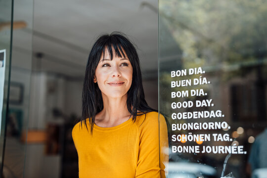 Smiling mature woman standing at beach