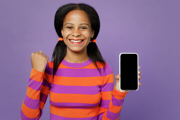 Little kid teen girl of African American ethnicity 15 year old wear striped orange sweatshirt hold...