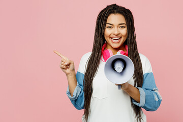 Young woman of African American ethnicity in white sweatshirt casual clothes hold in hand megaphone...