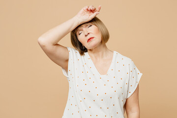 Sad sick ill blonde elderly woman 50s years old she wears casual clothes put hand on forehead...