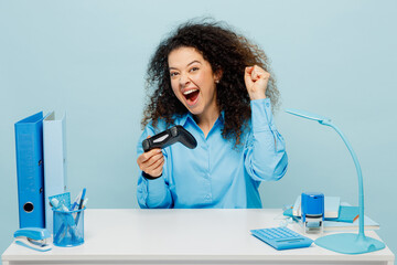 Young successful employee business woman wearing casual shirt sit work at white office desk hold in...