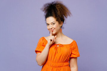 Young secret latin woman she wear orange blouse casual clothes say hush be quiet with finger on...