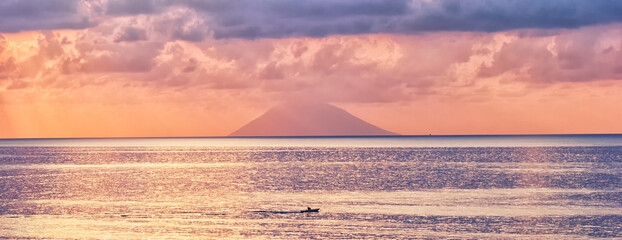 Evening landscape with sunset and Stromboli volcano silhouette on horizon of Tyrrhenian sea. Banner panoramic. View from Tropea city. - 621784259