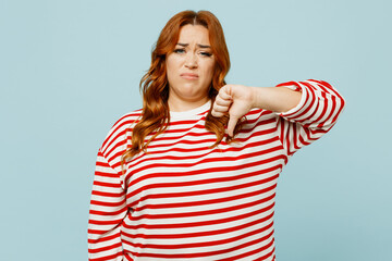 Young unhappy sad chubby overweight woman she wear striped red shirt casual clothes showing thumb...