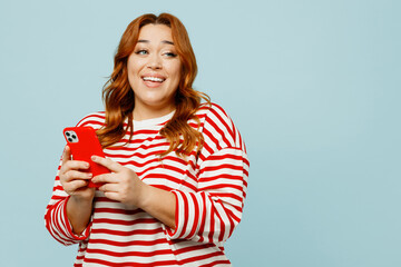 Cheerful happy young chubby overweight woman wears striped red shirt casual clothes hold in hand...