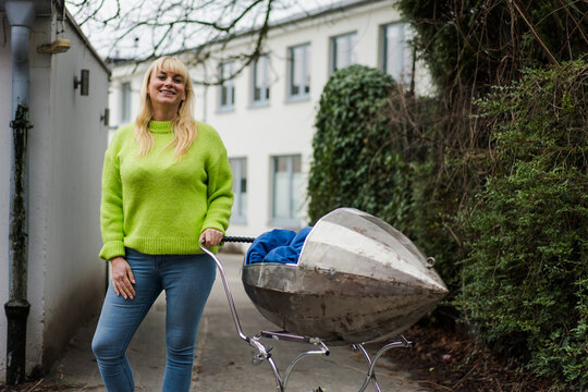 Man wearing backpack looking at stone temple tomb, Tuscany, Italy