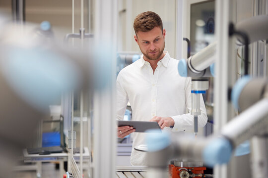 Smiling man with arms outstretched enjoying nature in rainy day