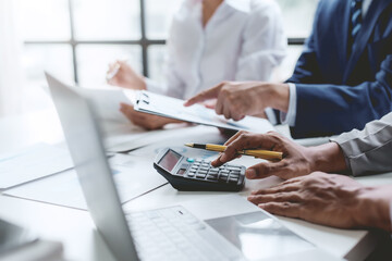 Group of business people working together on new project with planning analytical report at meeting. Businesspeople meeting together pointing to graph assess business profits.