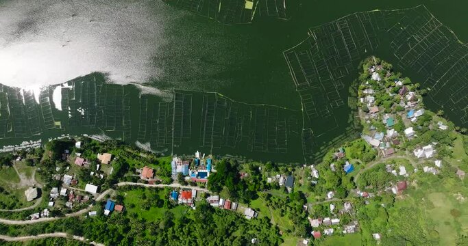 Top down view of Lake Sebu with sunlight reflection on water with fish farm. Mindanao, Philippines. Travel concept.