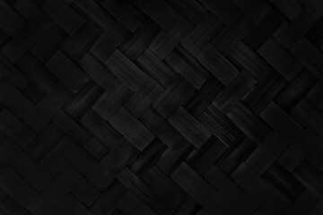 Old black bamboo weave texture background, pattern of woven rattan mat in vintage style.