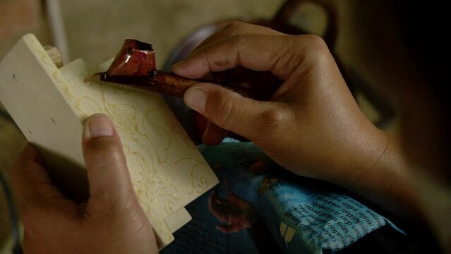 Batik application on accessories box decoration with wood material. Everything is done manually using canting, candles, stoves and dyes without patterns because the craftsmen are professionals