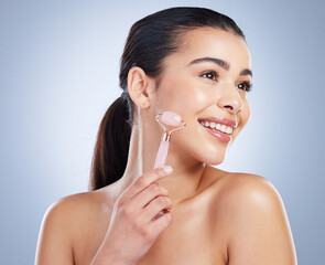 Derma roller, skincare and asian woman in studio for anti aging, cosmetic or face massage on grey...