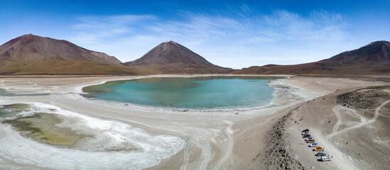 Naklejka premium Aerial view of the picturesque Laguna Verde with Licancabur Volcano, just one natural sight while traveling the scenic lagoon route through the Bolivian Altiplano - Panorama 