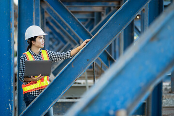 A Female Foreman Inspecting Objects at New Concrete Road and Bridge Construction Site, road Traffic is Critical Infrastructure.