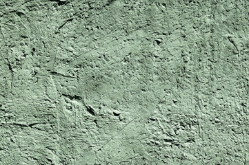 Green stone texture close-up. Rough green stone wall. Natural rock texture