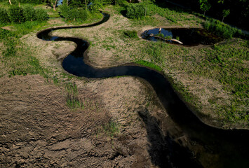 winding stream with ponds. people renewed the zigzagging cancel melioration, measures to maintain...