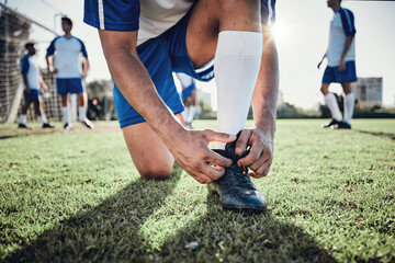 Hands, man and tie shoes on soccer field, prepare for training or fitness games. Closeup, football...