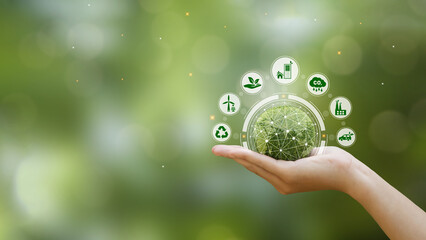 Hand holding green earth with clean energy icon standing on eco friendly icon. Green business and sustainable development. World earth day. Save of earth,saving environment,net zero emissions concept.