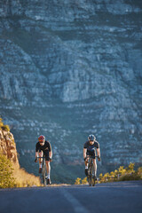Mountain, fitness and male athletes cycling on bicycles training for a race or marathon in nature....