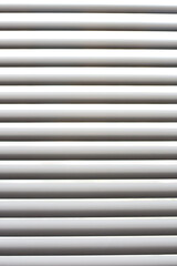 Obraz premium White horizontal blinds on the window. Decoration and convenience for home. Texture