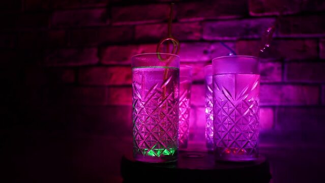 colorful cocktail in glass on dark background or Glasses of cocktails on bar background.Party club entertainment. Mixed light