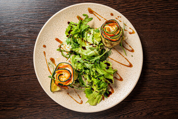 zucchini rolls with salad and sauce