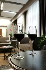 Two glasses of red wine in the business class lounge