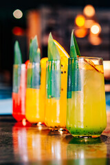 set Glass with tropical juice lemonafe with fruits on table