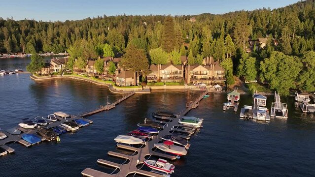 large lakeside mansions with boat docks on lake arrowhead in california AERIAL DOLLY PULLBACK RAISE UP