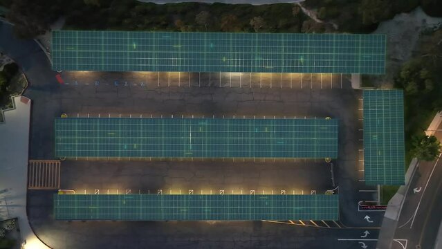 Modern photovoltaic EV charging station glowing on solar energy, Graphics overlay at night