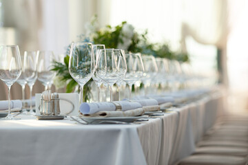 luxury elegant table setting dinner in a restaurant. glasses and dishes.
