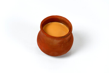 Fresh milk tea or indian karak chai or masala tea in clay cup on white background