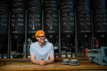 Coffeemaker. Professional hipster barista standing at bar counter in coffee shop.