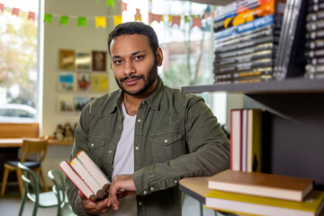 Young dark-skinned man reading book