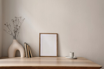 Elegant scandinavian interior, living room. Blank wooden picture frame mockup on table. Modern...