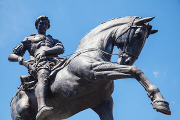 Roman military and cavalry. Roman rider warrior sits in the saddle on a horse and takes out his...