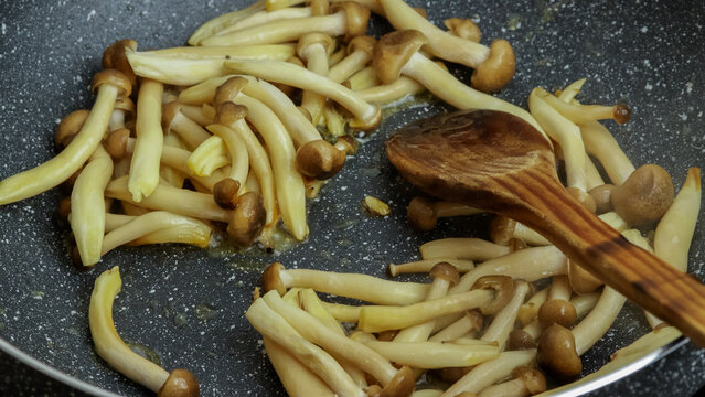 groupe de champignons bruns bunas Himeji cuisant dans une po&ecirc;le	