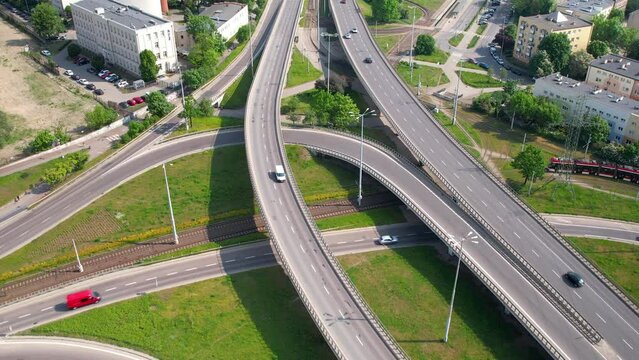 Gdansk Wezel Kliniczna large curved highway interchange with multiple connecting roads and cars traffic on summer day - aerial revealing  