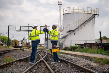 Engineer railway under inspection and checking construction railway switch and maintenance work on railroad station with equipment box .Engineer wearing safety uniform and safety helmet in work